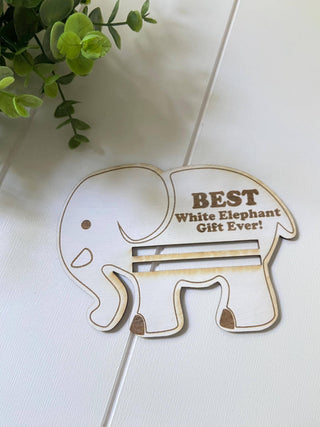 Empty wooden white elephant money holder showing the engraved design and bill slot