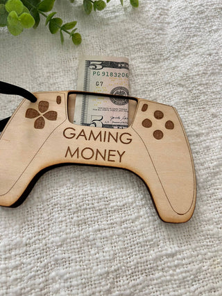Laser engraved wooden gaming controller money holder with a bill in the slot