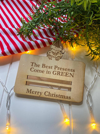 Laser engraved Merry Christmas money holder without money on a striped cloth
