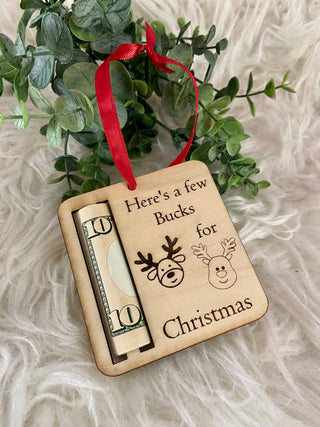 Laser engraved Christmas money holder ornament with a red ribbon and rolled bill