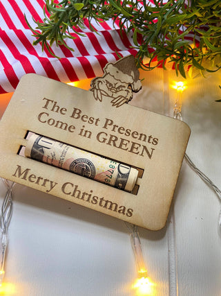 Close-up of the money holder engraved with The Best Presents Come in Green, Merry Christmas