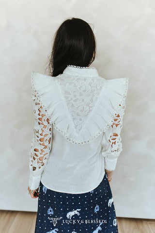 Ivory crochet lace top, close-up of covered front buttons and ruffle