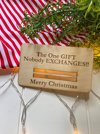 Laser engraved wooden Christmas money holder that says The One Gift Nobody Exchanges