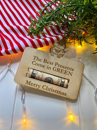 Best Presents Come in Green Christmas cash gift holder shown empty on a red and white striped cloth