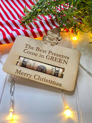 Best Presents Come in Green Christmas money holder with a rolled bill, greenery and string lights