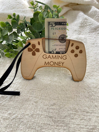 Close-up of Gaming Money controller money holder with a folded five dollar bill