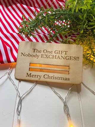 Laser engraved wooden Christmas money holder that says The One Gift Nobody Exchanges