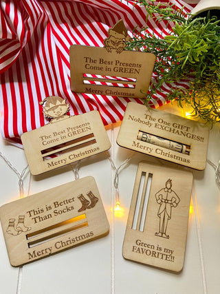 Collection of laser engraved wooden Christmas money holders including The Best Presents Come in Green and One Gift Nobody Exchanges designs
