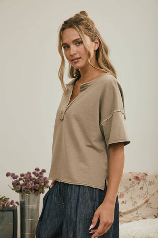 Mocha washed split neck raw edge knit top, side view