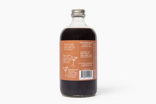 Front of the 16 oz glass bottle of Espresso Martini Cocktail and Mocktail Mixer with orange label