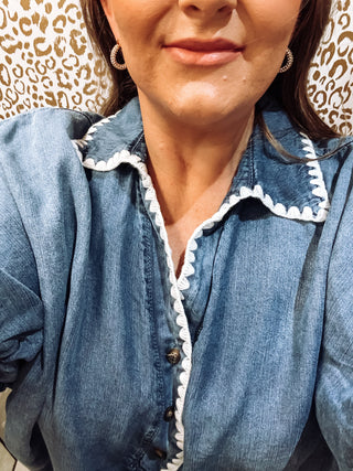 Front view of crochet trim denim puff sleeve blouse