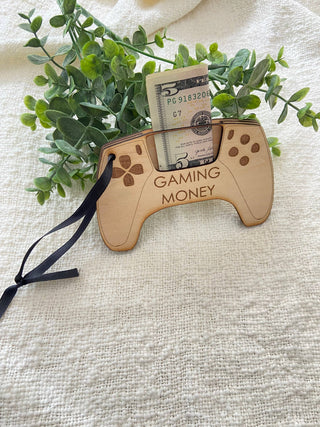 Gaming Money controller money holder with a bill, greenery and black ribbon on a linen background