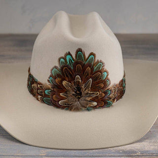 Western Feather Hat Band - Canyon adorning a beige hat, featuring boho feathers, perfect for Jayden Layne size-inclusive boutique style