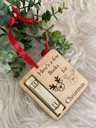 Here's a Few Bucks for Christmas reindeer ornament with a rolled bill and greenery
