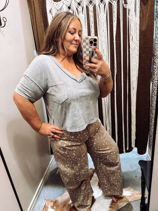 Grey washed V-neck boxy crop tee with chest pocket, raw edge seams and side slits styled with light fawn print wide leg pants