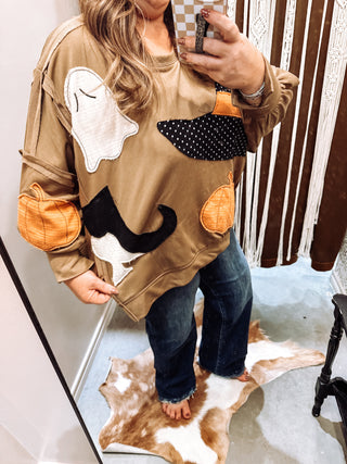 Halloween patchwork sweatshirt with raw edge ghost and pumpkin appliqué styled with dark wide leg jeans, photo 2