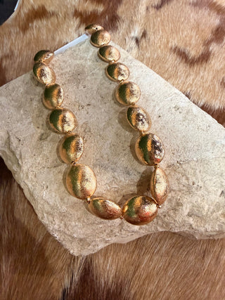 Model wearing chunky brushed oval bead collar necklace