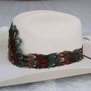 Western Feather Hat Band - Canyon on a white hat with blue and brown feathers, Jayden Layne size-inclusive boutique western style