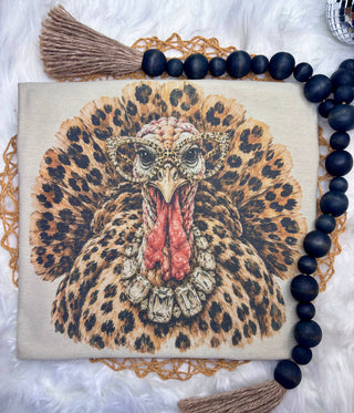 Tan sublimation graphic tee with a front-facing leopard print turkey wearing leopard cat-eye glasses and a crystal necklace