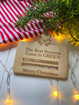 Empty Christmas money holder engraved with The Best Presents Come in Green
